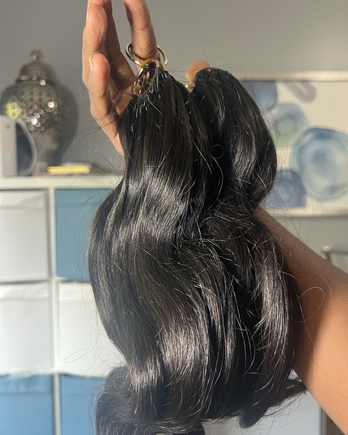 Monroe body wave 4K Feather Crochet packs held by the rings to show length