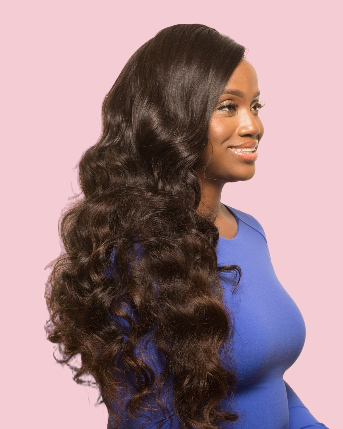 Model wearing a Monroe body wave Signature Set, side view, long full waves