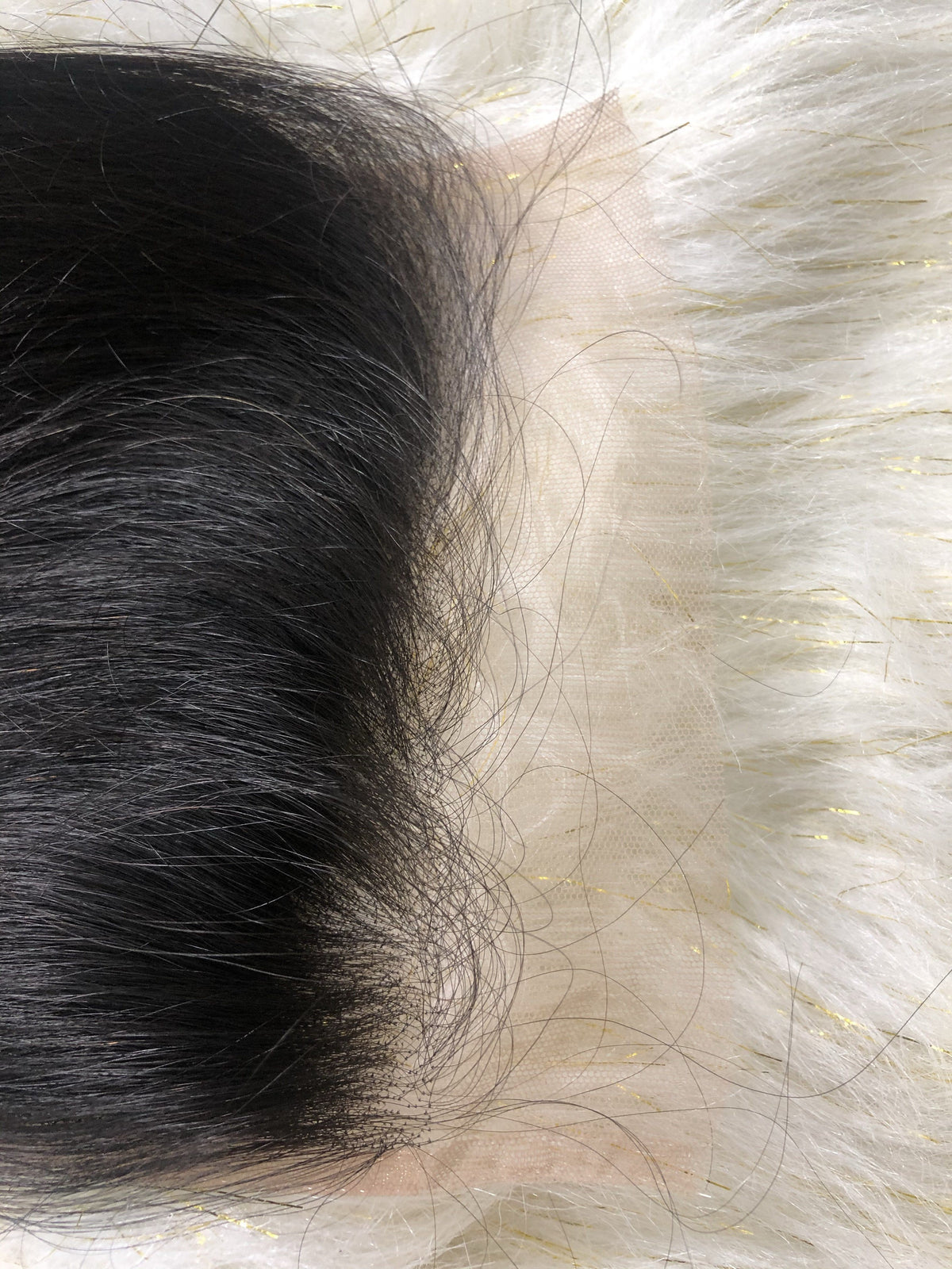 Close-up of Monroe body wave HD lace closure base against light background