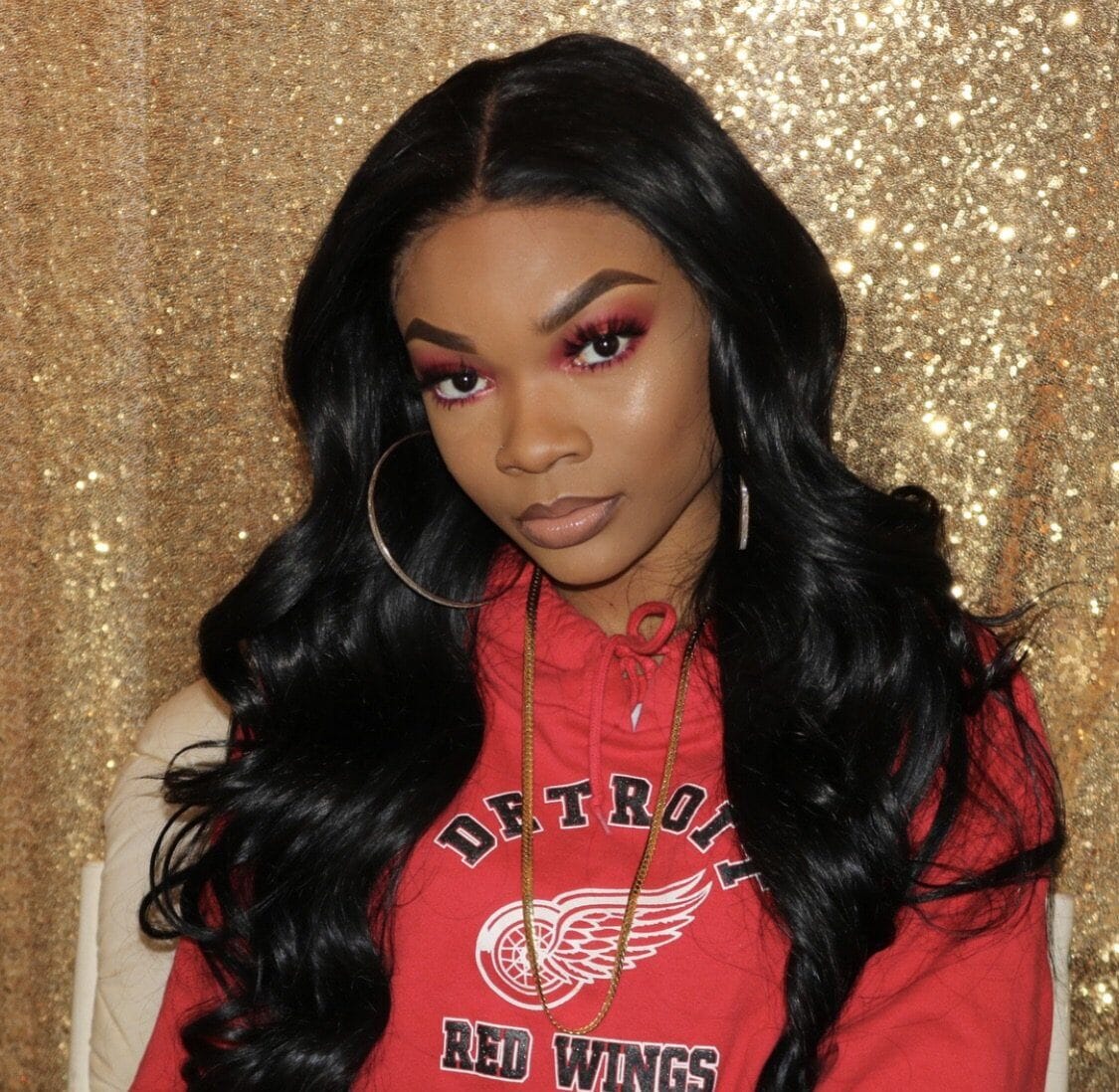 Customer wearing an Ansley straight hair install styled with loose waves